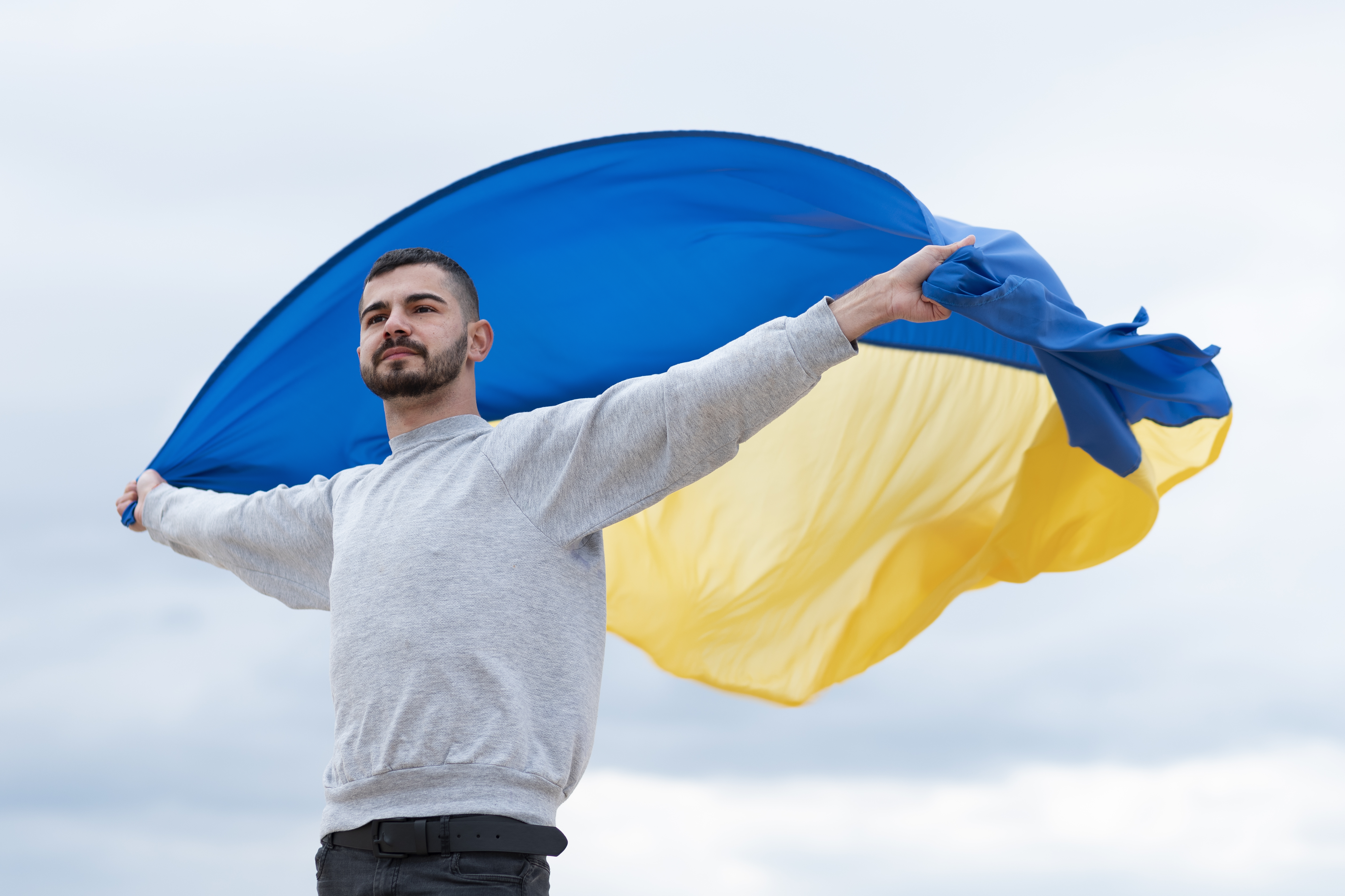 medium-shot-man-holding-ukrainian-flag.jpg